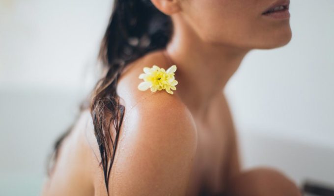 Woman in tub with wet hair relaxing