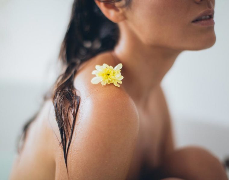 Woman in tub with wet hair relaxing