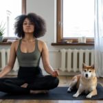Woman sitting in yoga post with dog